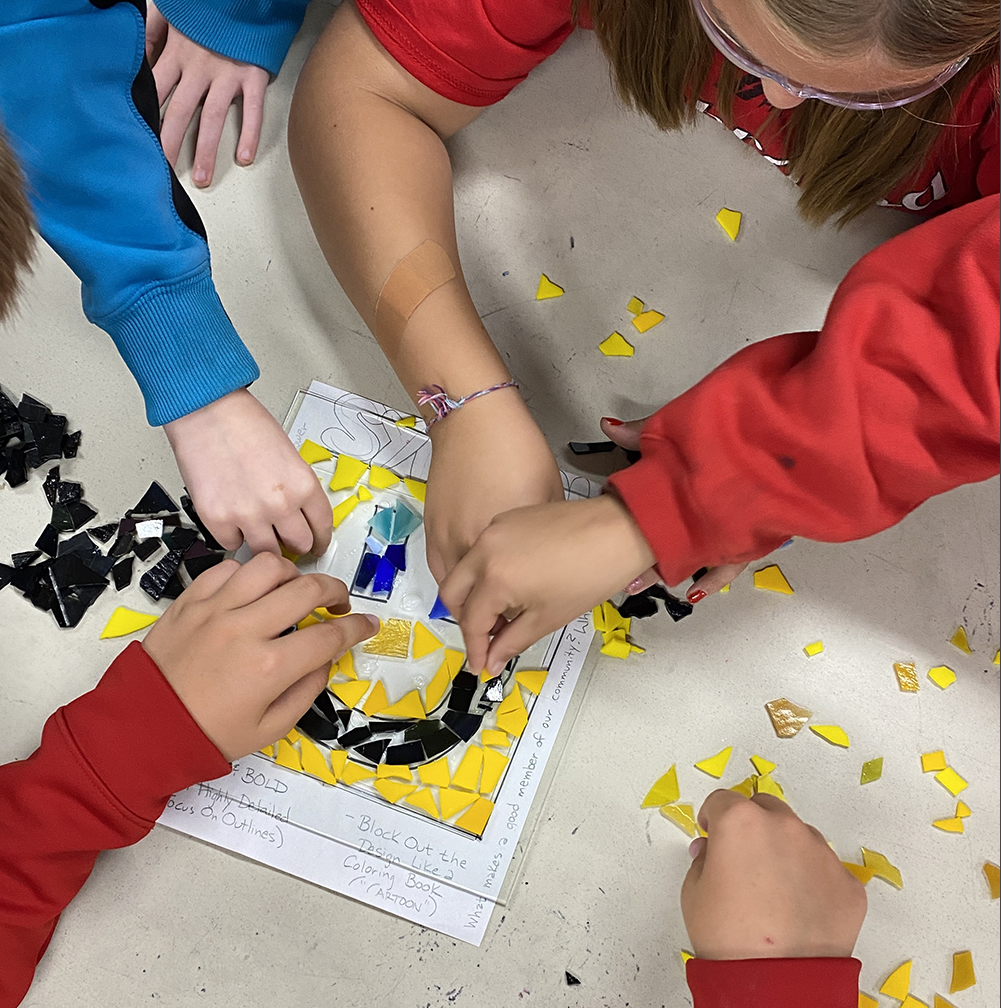 Students adding glass to a collaborative window
